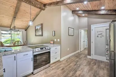 a large kitchen with white appliances and wooden ceilings at Beautiful Large close to Skiing / Wine Tasting! in Pioneer