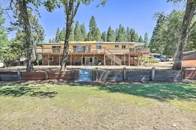 a large yellow house with trees in front of it at Beautiful Large close to Skiing / Wine Tasting! in Pioneer