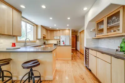 a kitchen with wooden cabinets and a counter top at 5 Mi to Northstar Resort! Family Home with Hot Tub in Truckee