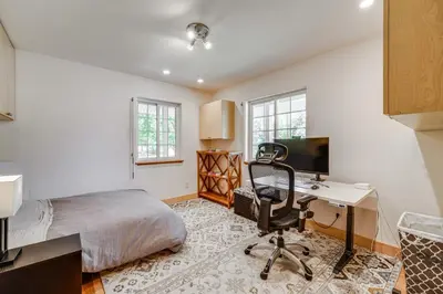 a bedroom with a bed and a desk with a computer at 5 Mi to Northstar Resort! Family Home with Hot Tub in Truckee