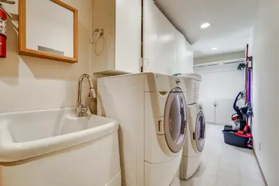a white laundry room with a sink and a washing machine at 5 Mi to Northstar Resort! Family Home with Hot Tub in Truckee