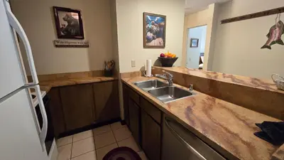 a kitchen with a sink and a refrigerator at Eagle Summit Collection in Mammoth Lakes
