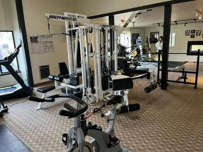a gym with several treadmills and machines at Eagle Summit Collection in Mammoth Lakes