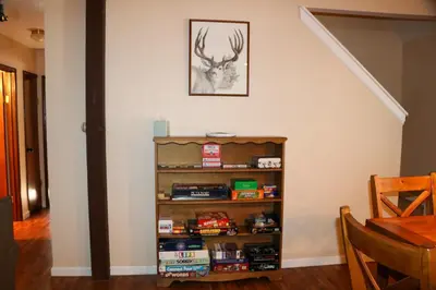 a book shelf in the corner of a room at Bear Meadow Cabin at Shaver Lake in Shaver Lake
