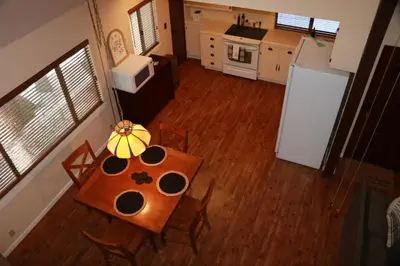 an overhead view of a kitchen with a table and refrigerator at Bear Meadow Cabin at Shaver Lake in Shaver Lake