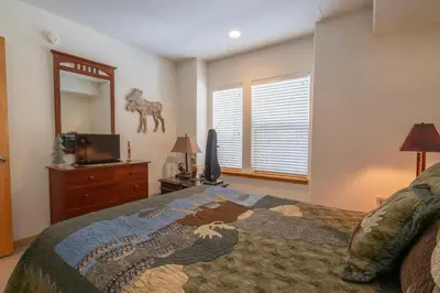 a bedroom with a bed with a horse statue on the wall at RR-Hideaway_Down_Cyn 104 in June Lake