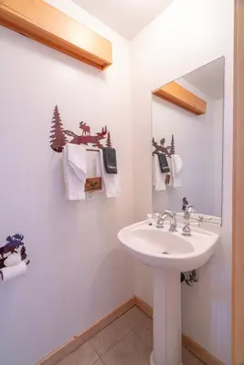 a bathroom with a sink and a mirror at RR-Hideaway_Down_Cyn 104 in June Lake