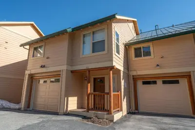a house with two garage doors on a street at RR-Hideaway_Down_Cyn 105 in June Lake