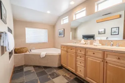 a bathroom with a tub and a sink at RR-Hideaway_Down_Cyn 105 in June Lake