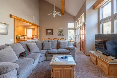 a living room with a couch and a tv at RR-Hideaway_Down_Cyn 105 in June Lake