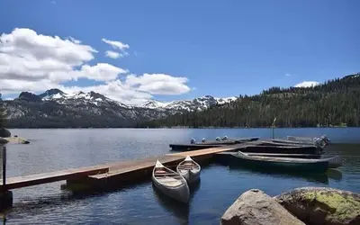 two boats are docked at a dock on a lake at The Lookout Loft Great views and King Sized Bed in Kirkwood