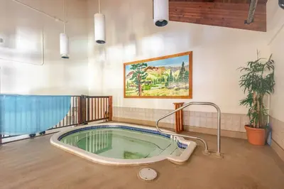 a jacuzzi tub in the middle of a room at The Lookout Loft Great views and King Sized Bed in Kirkwood