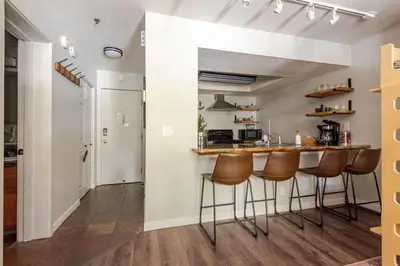 a kitchen with a counter and stools in a room at Modern Kirkwood One Bedroom with Deck in Kirkwood