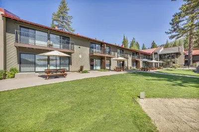a large building with a picnic table and benches at 242 Bldg C condo in Truckee