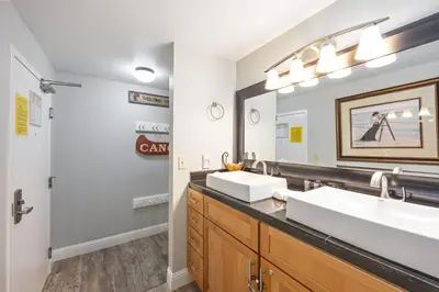 a bathroom with two sinks and a large mirror at 125 Bldg B condo in Truckee