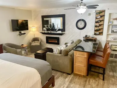 a bedroom with a bed and a couch and a fireplace at 125 Bldg B condo in Truckee