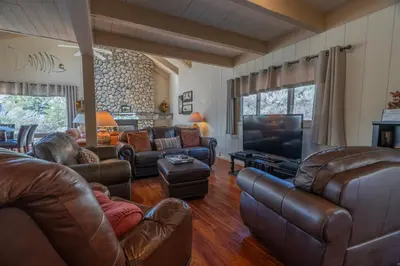 a living room with leather furniture and a flat screen tv at RR-Villa Lago STR AP 18-003 in June Lake