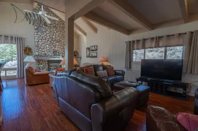 a living room with a couch and a television at RR-Villa Lago STR AP 18-003 in June Lake