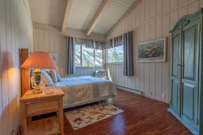 a bedroom with a bed and a lamp on a table at RR-Villa Lago STR AP 18-003 in June Lake