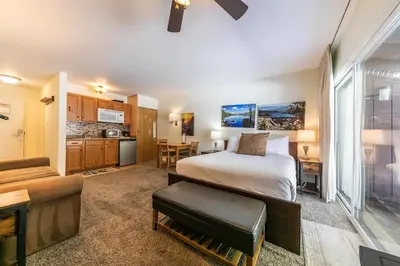 a hotel room with a bed and a kitchen at 212 Bldg B condo in Truckee