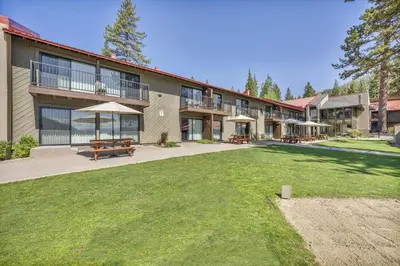 a large building with a patio and a yard at 212 Bldg B condo in Truckee
