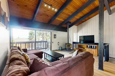 a living room with a couch and a television at Mammoth Point 119 in Mammoth Lakes