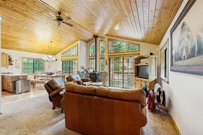 a living room with two couches and a kitchen at Chill on the Hill in Truckee