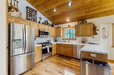 a kitchen with wooden cabinets and stainless steel appliances at Chill on the Hill in Truckee