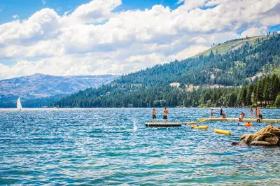 a group of people standing on a dock in a lake at Chill on the Hill in Truckee