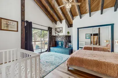 a bedroom with two beds and a large window at The Bunk and Birch Retreat in South Lake Tahoe