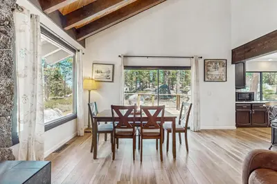 a kitchen and dining room with a table and chairs at The Bunk and Birch Retreat in South Lake Tahoe