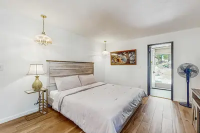 a white bedroom with a bed and a fan at The Bunk and Birch Retreat in South Lake Tahoe