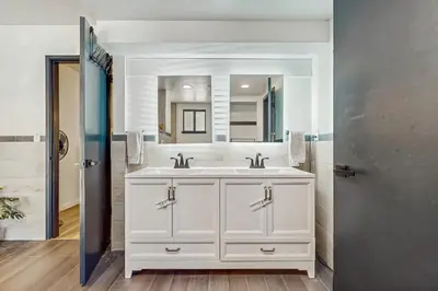 a bathroom with a white sink and a mirror at The Bunk and Birch Retreat in South Lake Tahoe