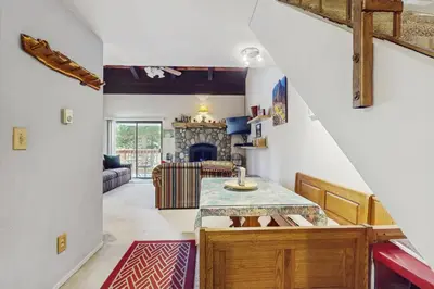 a kitchen with a table and a living room at Woodstock and Snoopy in Incline Village