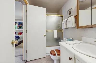 a white bathroom with a sink and a toilet at Woodstock and Snoopy in Incline Village