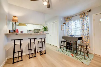 a kitchen with a counter and bar stools in a room at 1 Mi to Reno-Sparks Family Retreat with Fireplace! in Reno