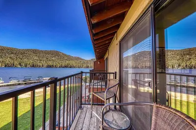 a balcony with chairs and a view of a lake at 244 Bldg C condo in Truckee