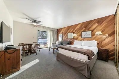 a hotel room with a bed and a dining room at 135 Bldg C condo in Truckee