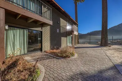 a building with a brick walkway next to a tree at 135 Bldg C condo in Truckee