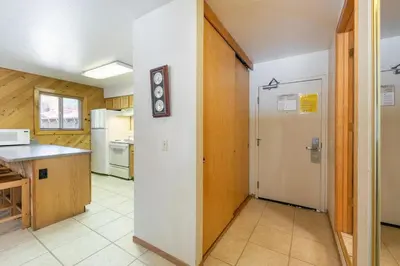 a kitchen with a white refrigerator and a counter at 117 Bldg B condo in Truckee