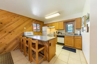 a kitchen with wooden cabinets and a white refrigerator at 117 Bldg B condo in Truckee