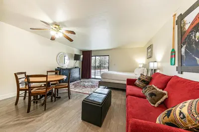a living room with a red couch and a table at 233 Bldg C condo in Truckee