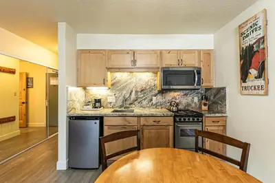 a kitchen with wooden cabinets and a wooden table at 233 Bldg C condo in Truckee
