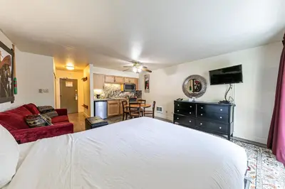 a bedroom with a white bed and a living room at 233 Bldg C condo in Truckee