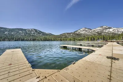 a dock on a lake with mountains in the background at 115 Bldg B studio in Truckee