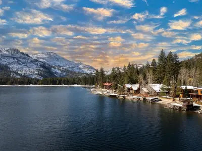 a view of a lake with houses and mountains at 124 Bldg B studio in Truckee