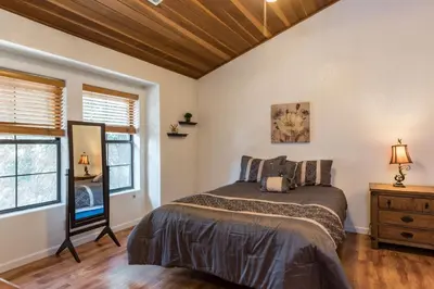 a bedroom with a bed and a wooden ceiling at Inside Yosemite Mountain Beauty in Yosemite West