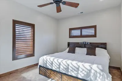 a bedroom with a bed with a ceiling fan at Reno Basecamp 2 King Suites, Walk to Food and Fun in Reno