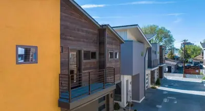 a row of houses with balconies on a street at Reno Basecamp 2 King Suites, Walk to Food and Fun in Reno