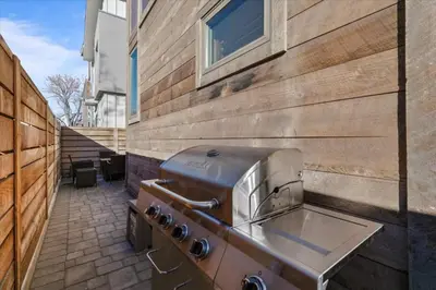 a barbecue grill on the side of a building at Reno Basecamp 2 King Suites, Walk to Food and Fun in Reno